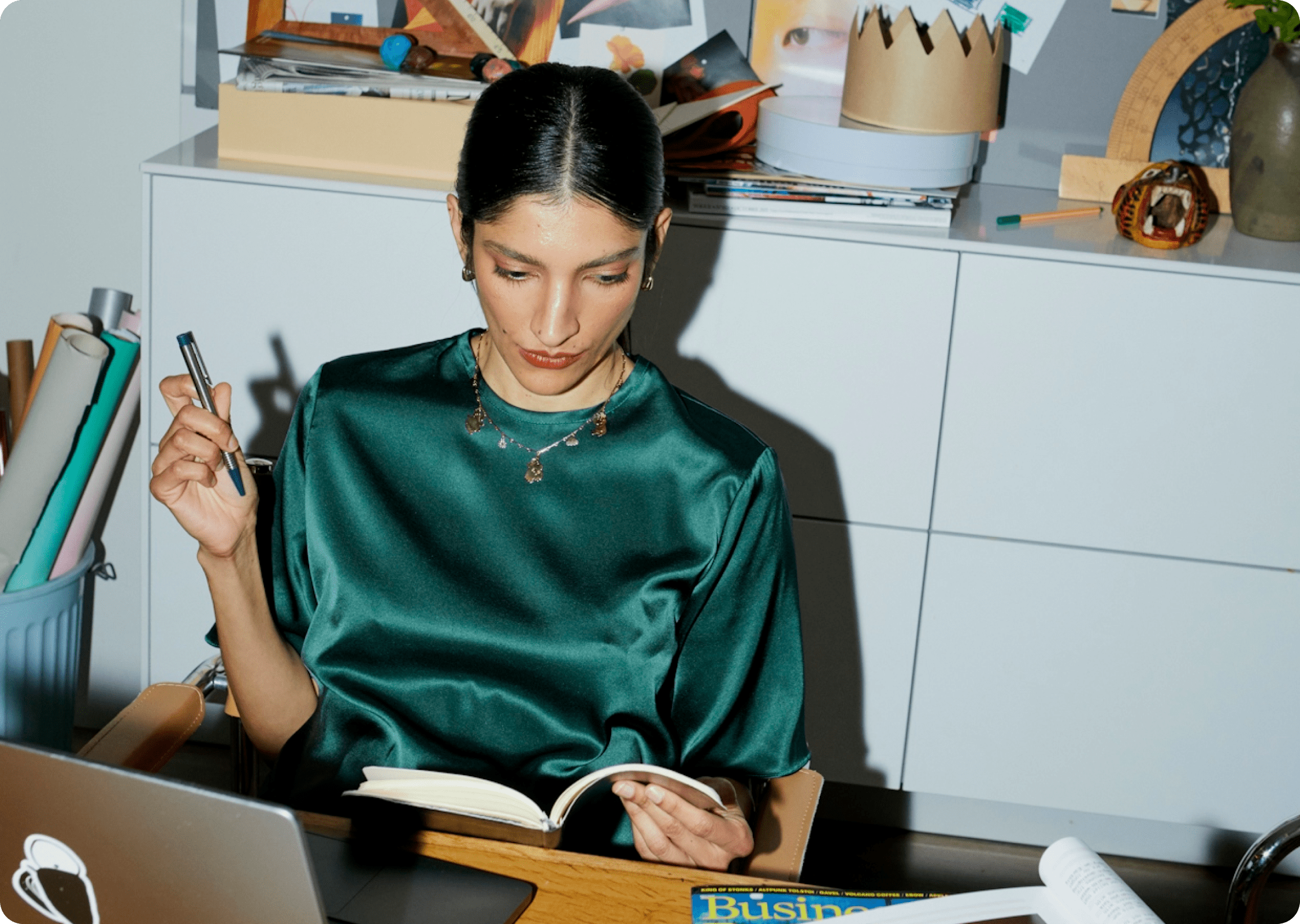A renter sitting at a desk with a laptop and notebook, reviewing expenses and planning for rent and upcoming bills.